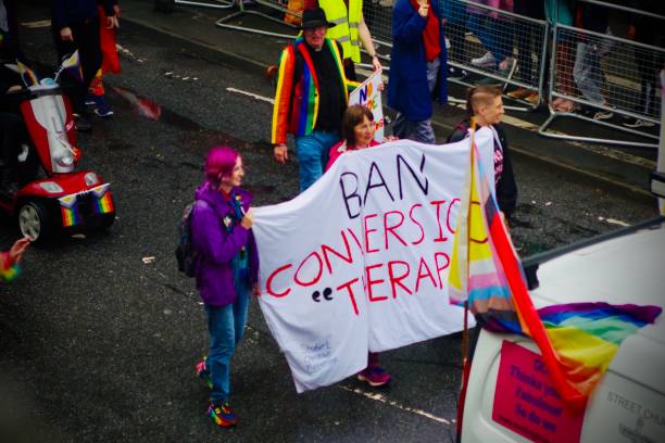 People carrying "Ban Conversion Therapy" banner at Brighton Pride Parade People carrying "Ban Conversion Therapy" banner at Brighton Pride Parade. Captured during Brighton Pride Parade on the 5th of August 2023 during Storm Antoni at Preston Road by the entrance to Preston Park where the Pride parade ends. Brighton and Hove Pride is an annual LGBT pride event held in Brighton and Hove, England, organised by Brighton Pride. This community interest company promotes equality and diversity and advances education to eliminate discrimination against the lesbian, gay, bisexual and trans community. melbourne street crowd stock pictures, royalty-free photos & images