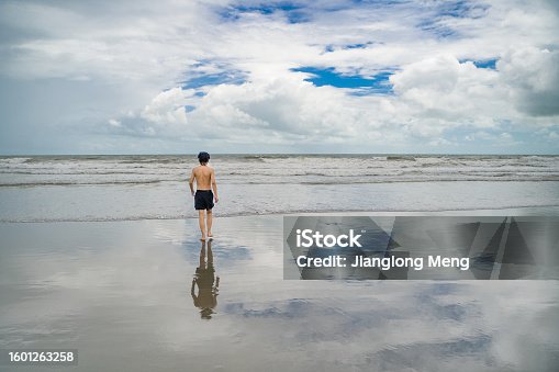 istock A boy running on a happy vacation by the sea 1601263258
