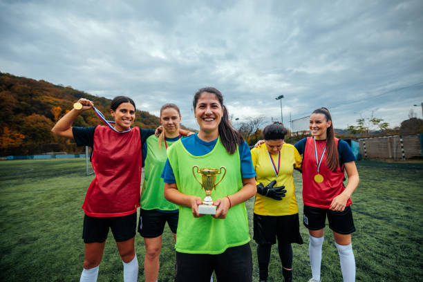 istock Soccer girls with trophy. 1601266444