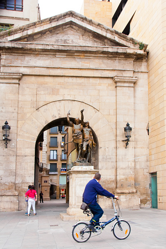 L'Arc del Pont (Arco del Puente), street bridge arch.  18th century. Lleida, Lérida, Catalonia, Spain. Ancient city doorway. Iberian warriors sculpture.