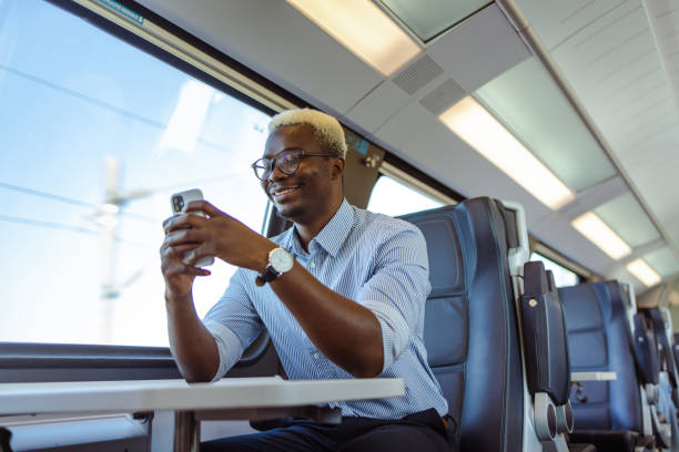 istock African American businessman using smart phone in train 1601284966