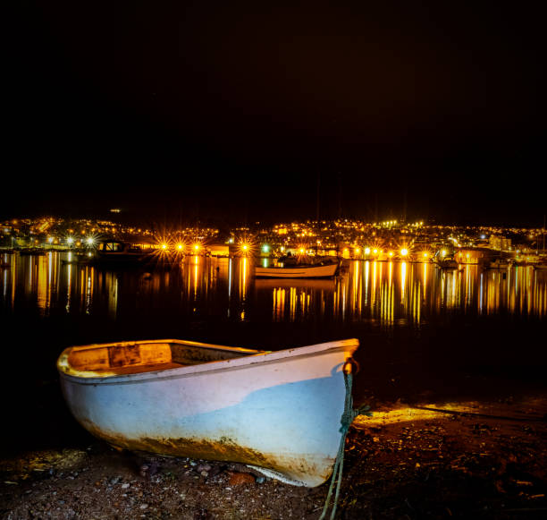 istock Rowing gig moored on Teignmouth 'back beach' at low tide at night. 1601289127