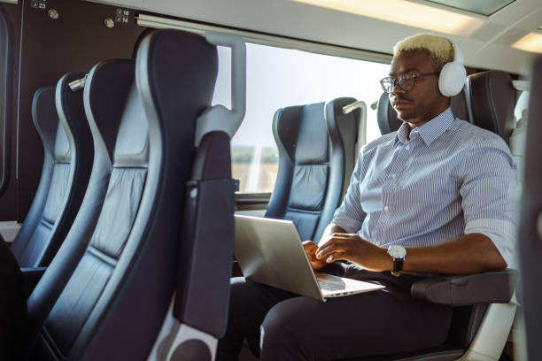istock African American businessman using laptop in train 1601293232