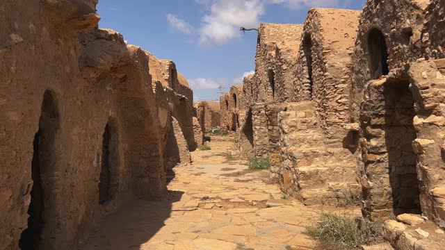 Walking through remains of Ksar Hadada village in Tunisia