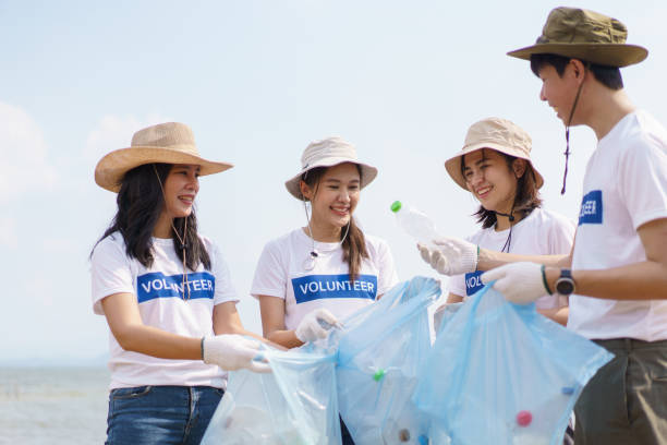 istock Group of volunteer cleaning lake shore. 1601321572