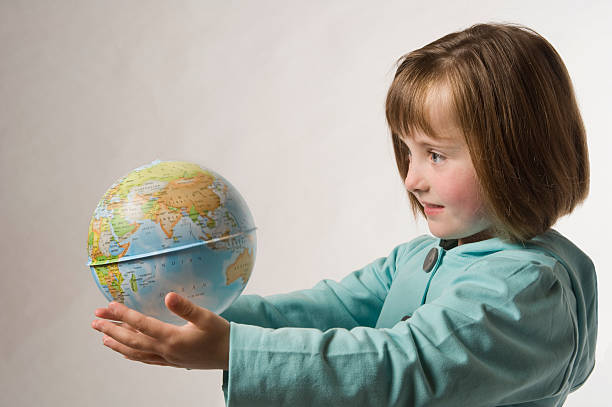 istock young girl holding globe 160134555