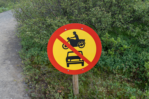 Sign for motorcycles and cars or any motorized vehicles not allowed ahead on the road or trail