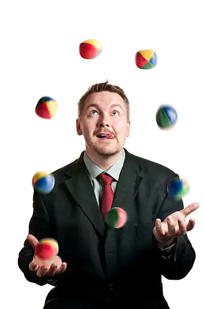 A Businessman juggling balls on white background