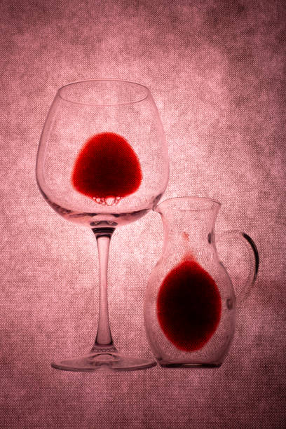 istock Glass and decanter with red wine on a burgundy background 1601370706