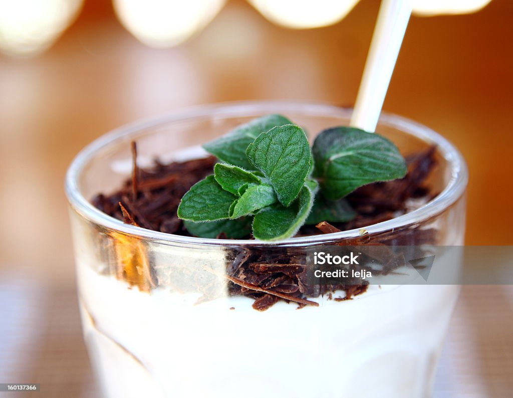 close-up dessert tiramisu in glass bowl close-up dessert tiramisu in glass bowl decorated with mint Beige Stock Photo