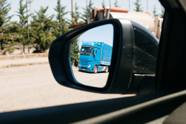 istock Truck as seen from rear view mirror 1601374726