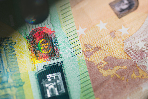 Benjamin Franklin peeking through  50 euro banknotes for design purpose