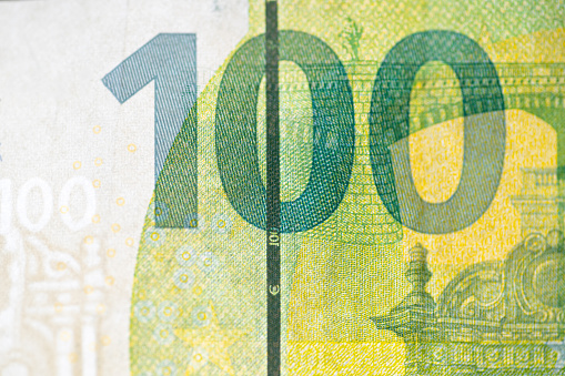 A 100 euro bill with a security band visible