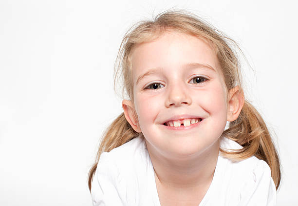 Happy young girl looking at camera and smiling stock photo