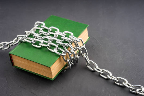 istock a large green book chained on a gray background 1601380726
