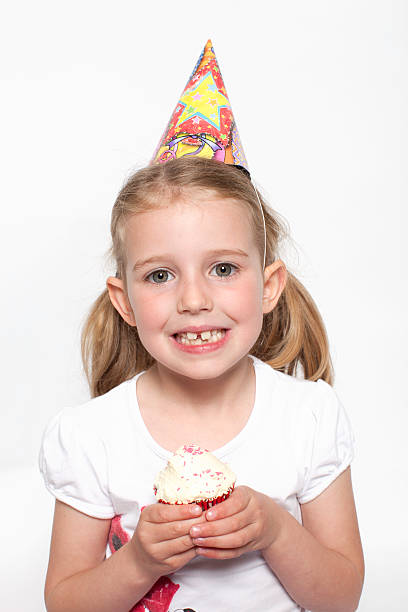 Young girl holding a cupcake stock photo