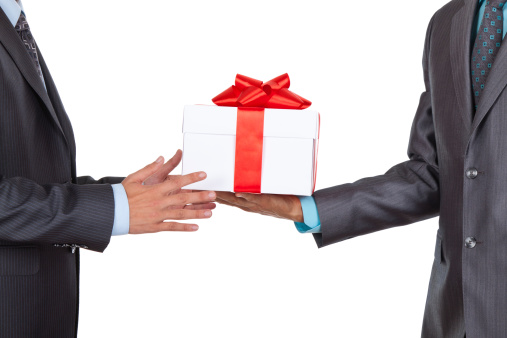 Businessmen holding gift box isolated over white background