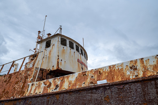 An abandoned fishing boat lies on a boat launch ramp in a tiny Nova Scotian fishing village.