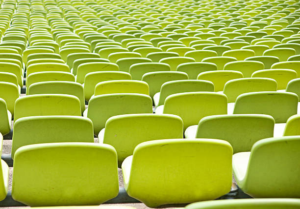istock Empty plastic seats at stadium, open door sports arena 160139121