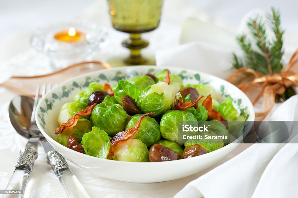 A bowl of Brussels sprouts with bacon and chestnuts brussels sprouts with bacon and chestnuts for Christmas Brussels Sprout Stock Photo