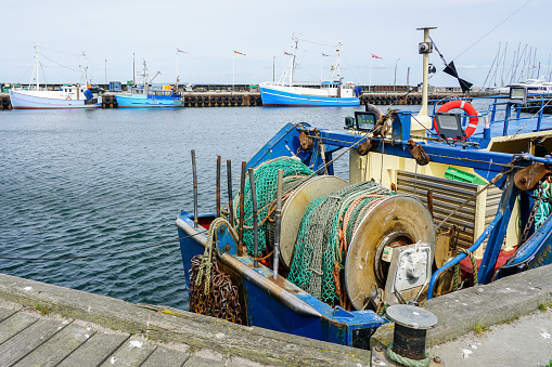 Fishing boat anchored at port, traditional vessel closeup with wrapped fishing nets and equipment, fisheries, Denmark, Europe