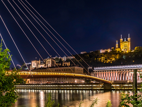 Lyon, France, 23.08.2019: View of illuminated Saint Georges footbridge, Vieux Lyon and Saone river by night in Lyon, France.