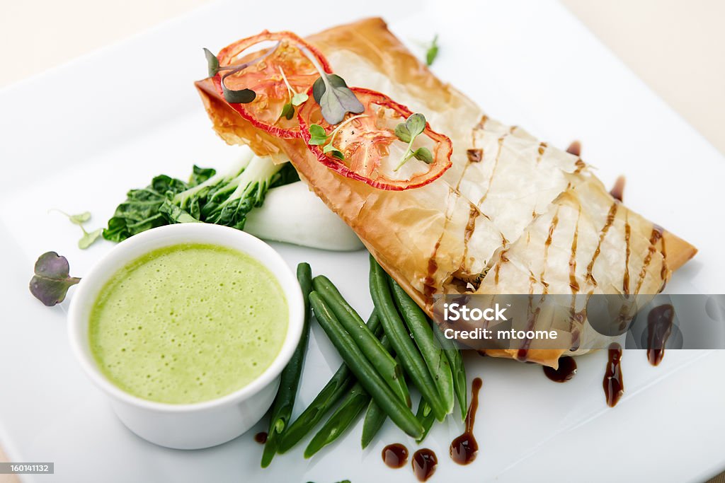 Sea-bass Chilean sea bass in papilliote with sauce Chile Stock Photo