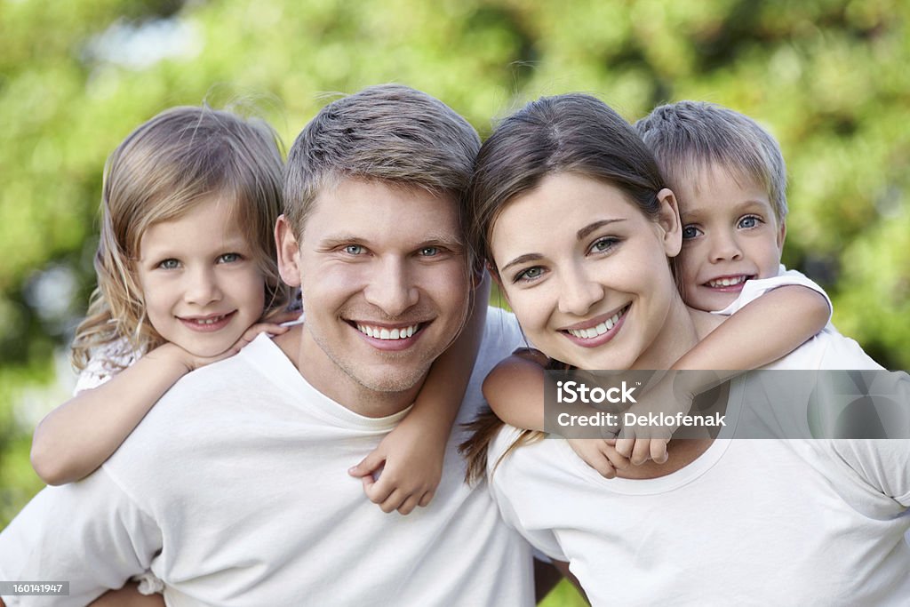 A family portrait of two parents and their two kids in white http://content.foto.mail.ru/mail/deklo-design/2/i-40.jpg 30-39 Years Stock Photo