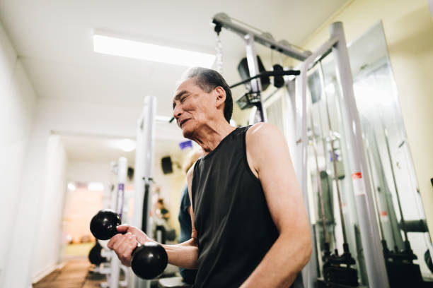 istock Senior man lifting dumbbells at the gym 1601423687