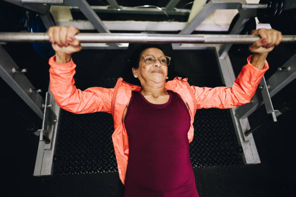 istock Senior woman using exercise machine at the gym 1601423986