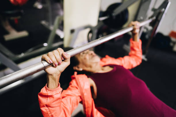 istock Senior woman using exercise machine at the gym 1601423988