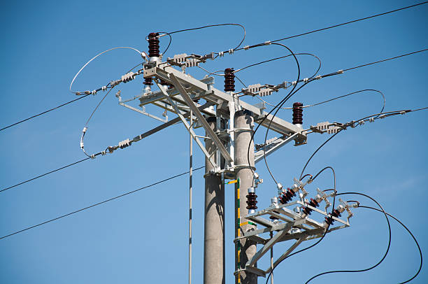 istock electric pole and high-voltage lines with insulators 160142808