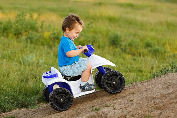 istock Little boy driving off road toy quad 160142929