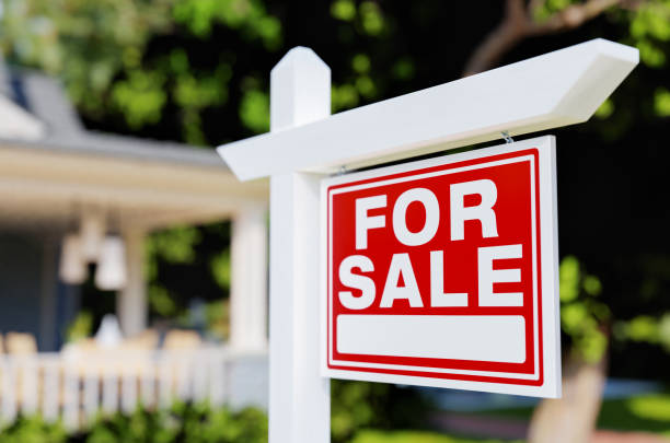For Sale Real Estate Sign In Front of House. stock photo