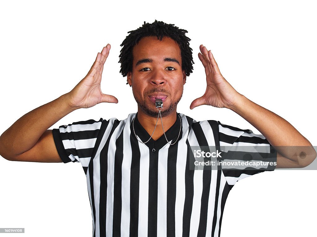 Black Male Referee Blowing a Whistle and Gesturing Male African American referee blowing on whistle and gesturing a generic play signal. African Ethnicity Stock Photo