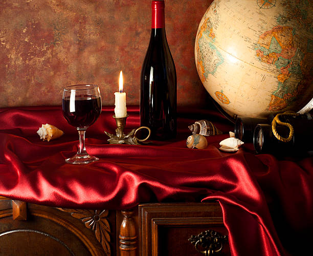 istock Still-life with a glass of red wine and globe 160144160