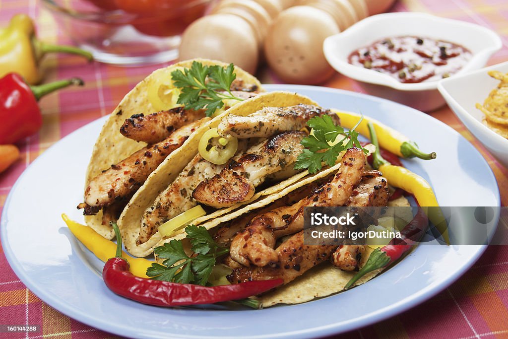 Grilled chicken in taco shells Grilled chicken meat and hot chili peppers in taco shells Chicken Meat Stock Photo