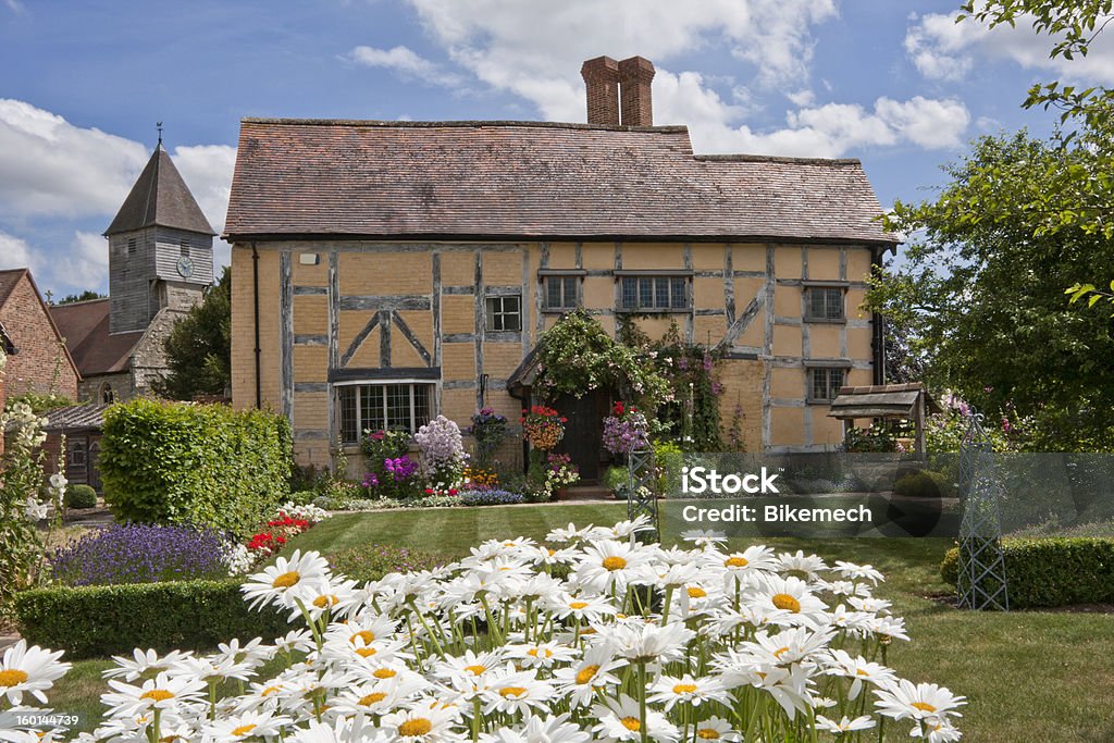 Village cottage Cottage and garden with village church in the background Church Stock Photo