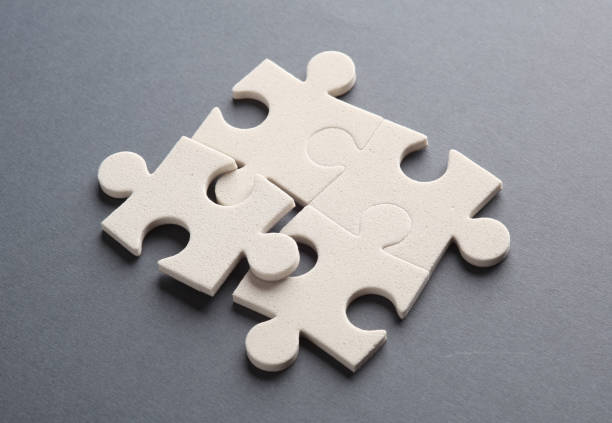 istock White jigsaw puzzle pieces on dark background. 1601450023