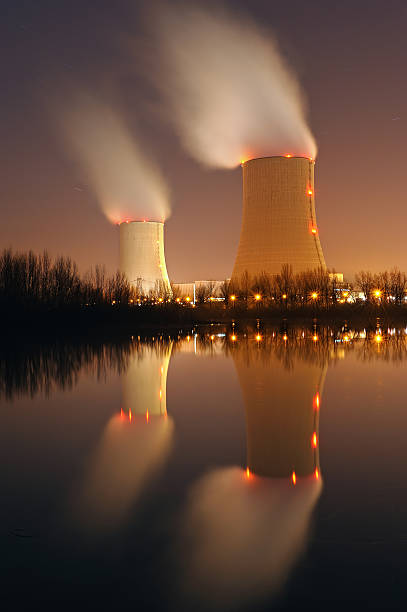 View of nuclear power plant with fumes coming out  stock photo