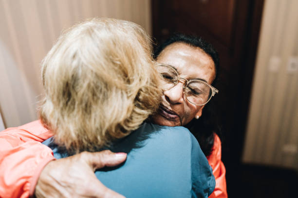 istock Senior friends embracing at home 1601467321