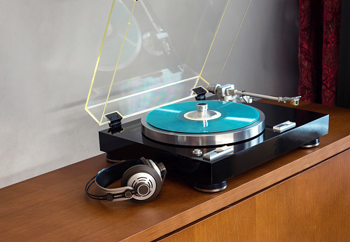 Vintage Stereo Turntable Record Player With Blue Colored Disk, Headphones and Black Weight Clamp