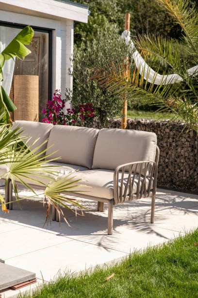 istock Outdoor garden living space with sofa couch, table and refreshment drinks on terrace patio 1601537063