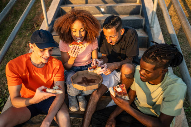istock Friends sharing a pizza outdoors 1601554005