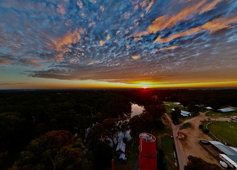 Arial shot of the sun rising over the Edward river in the small rural town of Deniliquin NSW Australia