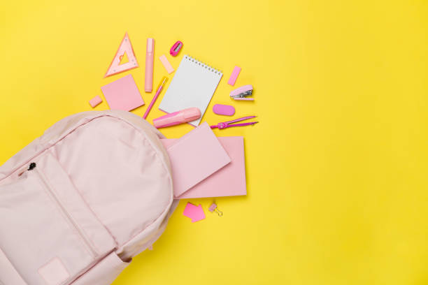 istock Pink school backpack with stationery on color background, top view 1601577765
