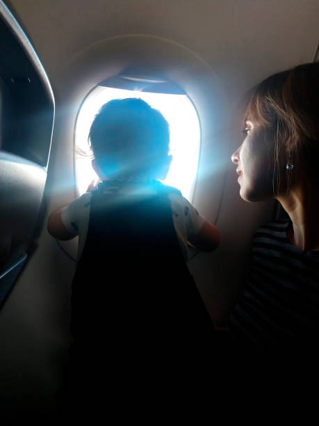 istock mother and son traveling by plane 1601578850