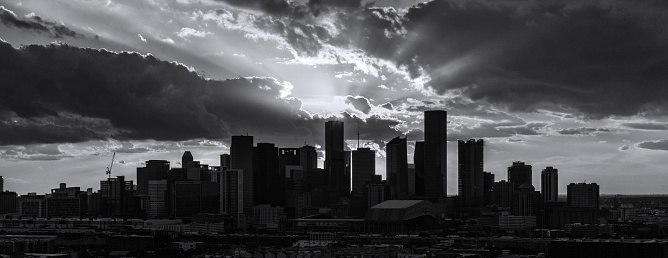 High contrast black and white image of the skyline of Houston, Texas silhouetted against the sunset on a late spring evening.