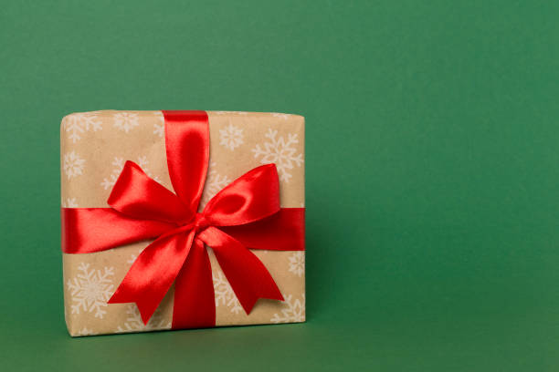 istock Gift box with red ribbon bow on color background 1601587706