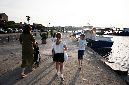 Tourists family walking on the promenade in Nessebar, Bulgaria.